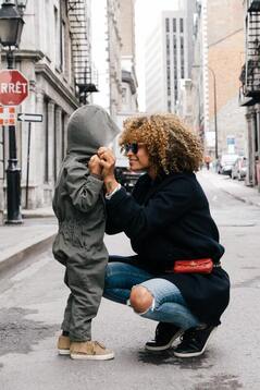 Mom kneeling in front of young child